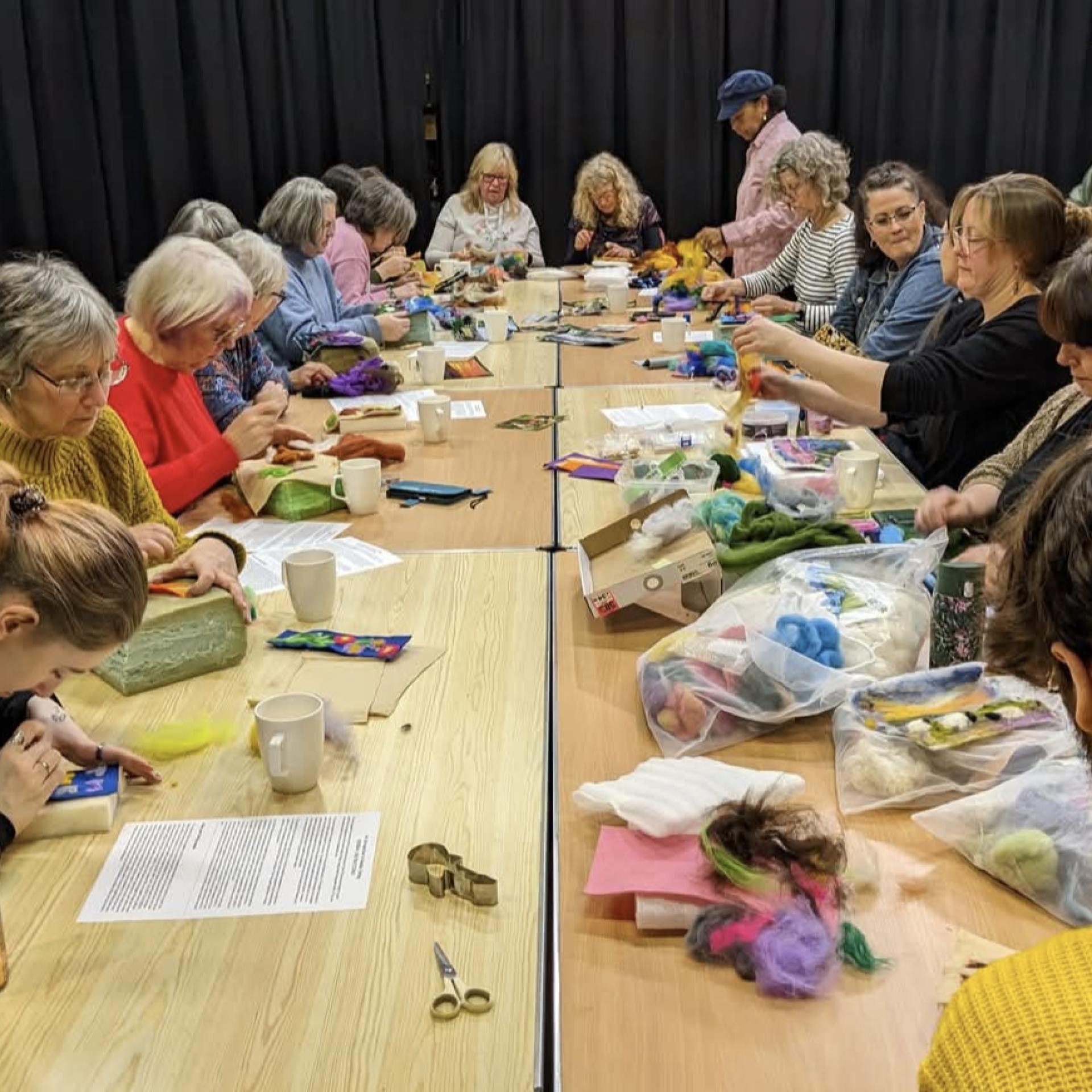 a group of people on a table doing art