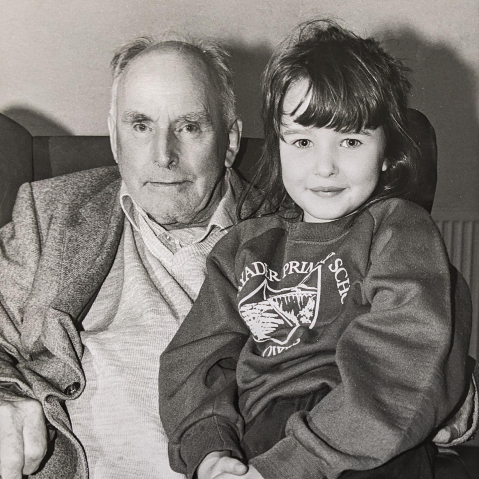 A black and white image of an old man a kid.